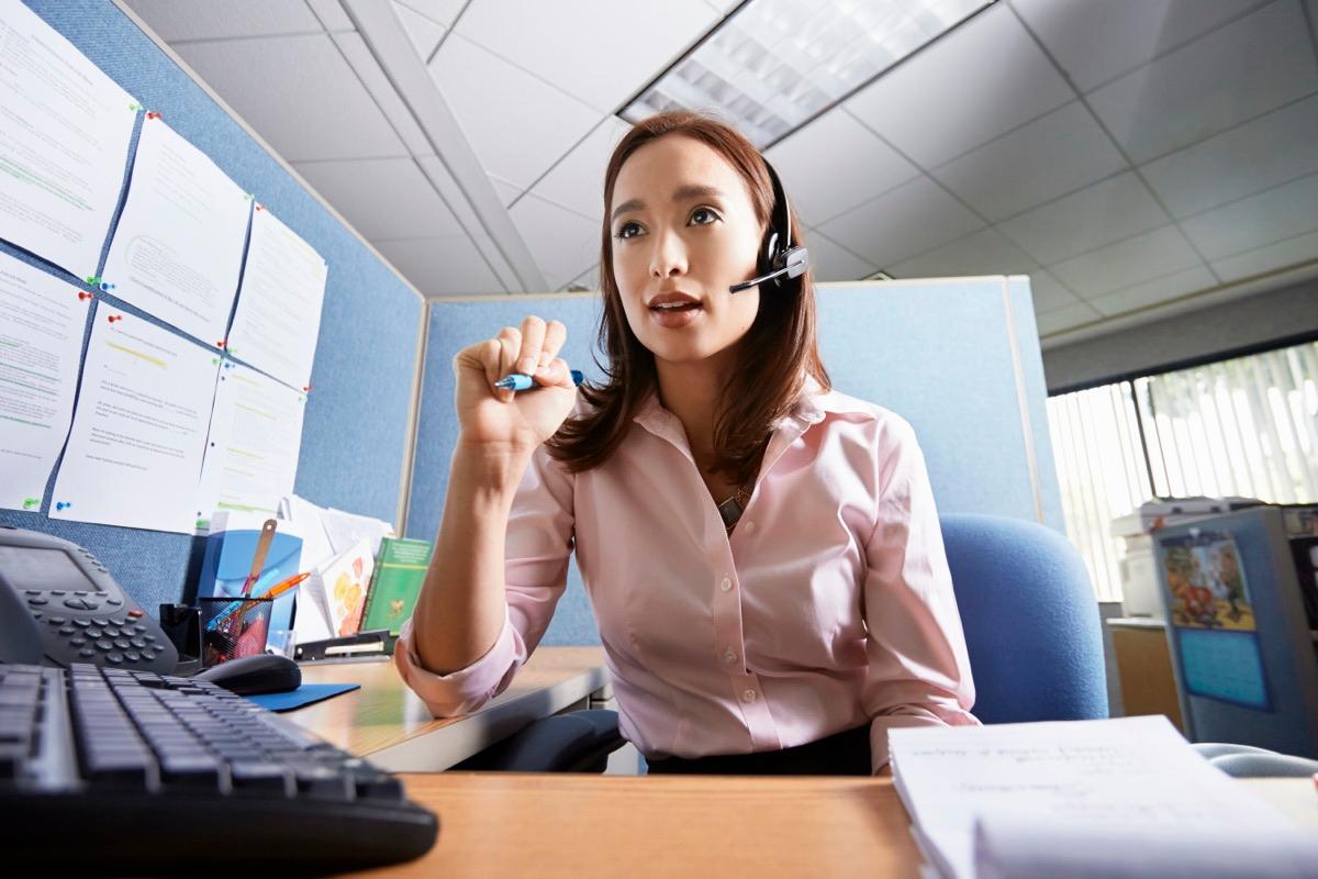Dispatcher at her desk on a headset coordinating today's jobs